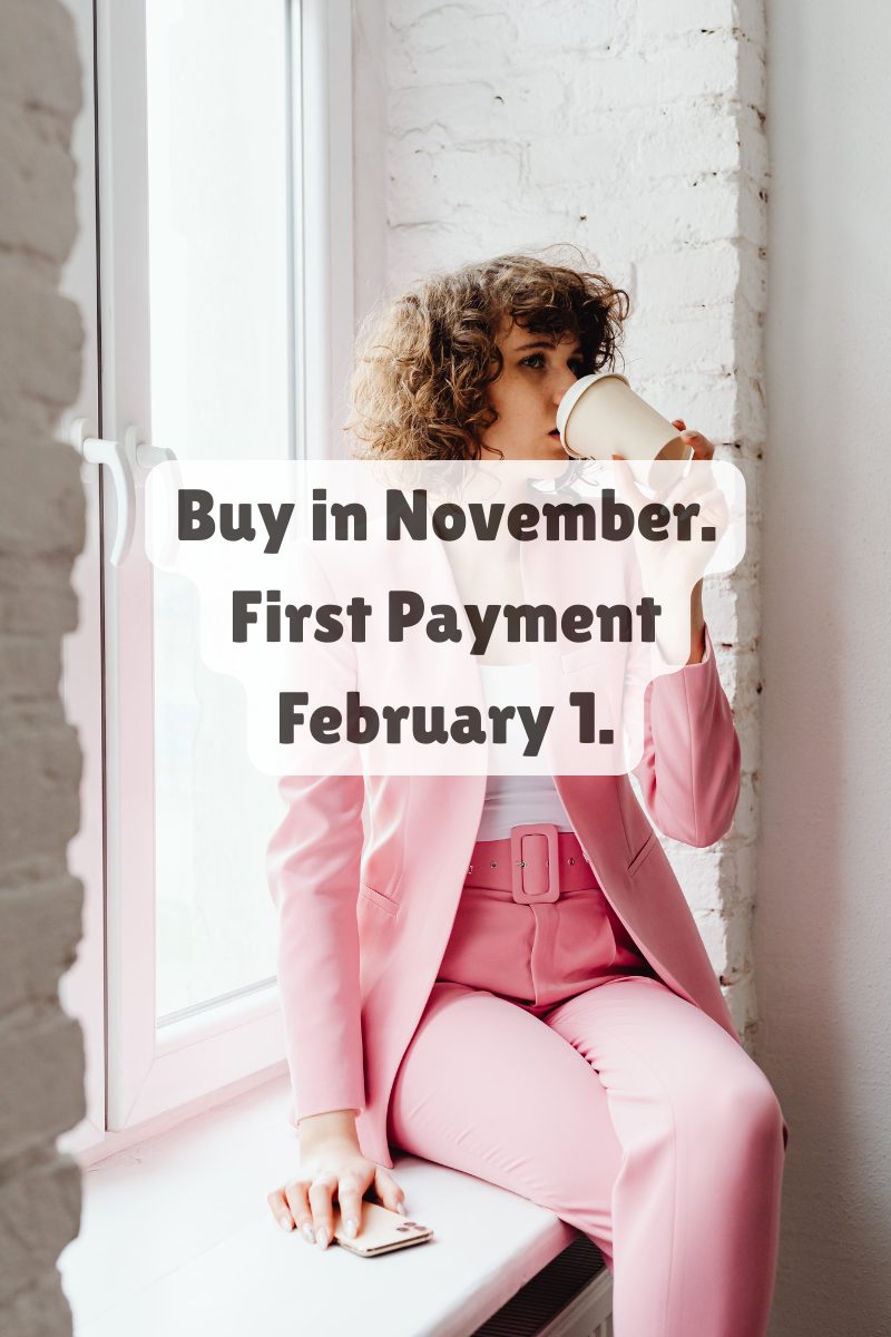 Young woman in a pink suit sitting by a window with coffee cup, representing confident homebuyers preparing to purchase before the holidays.