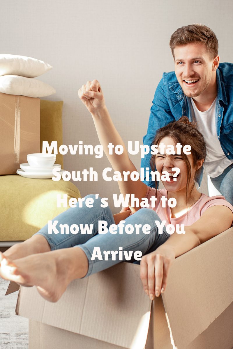 Happy couple unpacking boxes after moving to Upstate South Carolina, celebrating their new home.